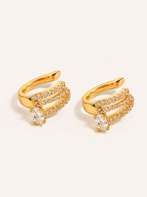 Gold triple row ear cuff earrings with clear oval cubic zirconia and pavé detailing in stainless steel.
