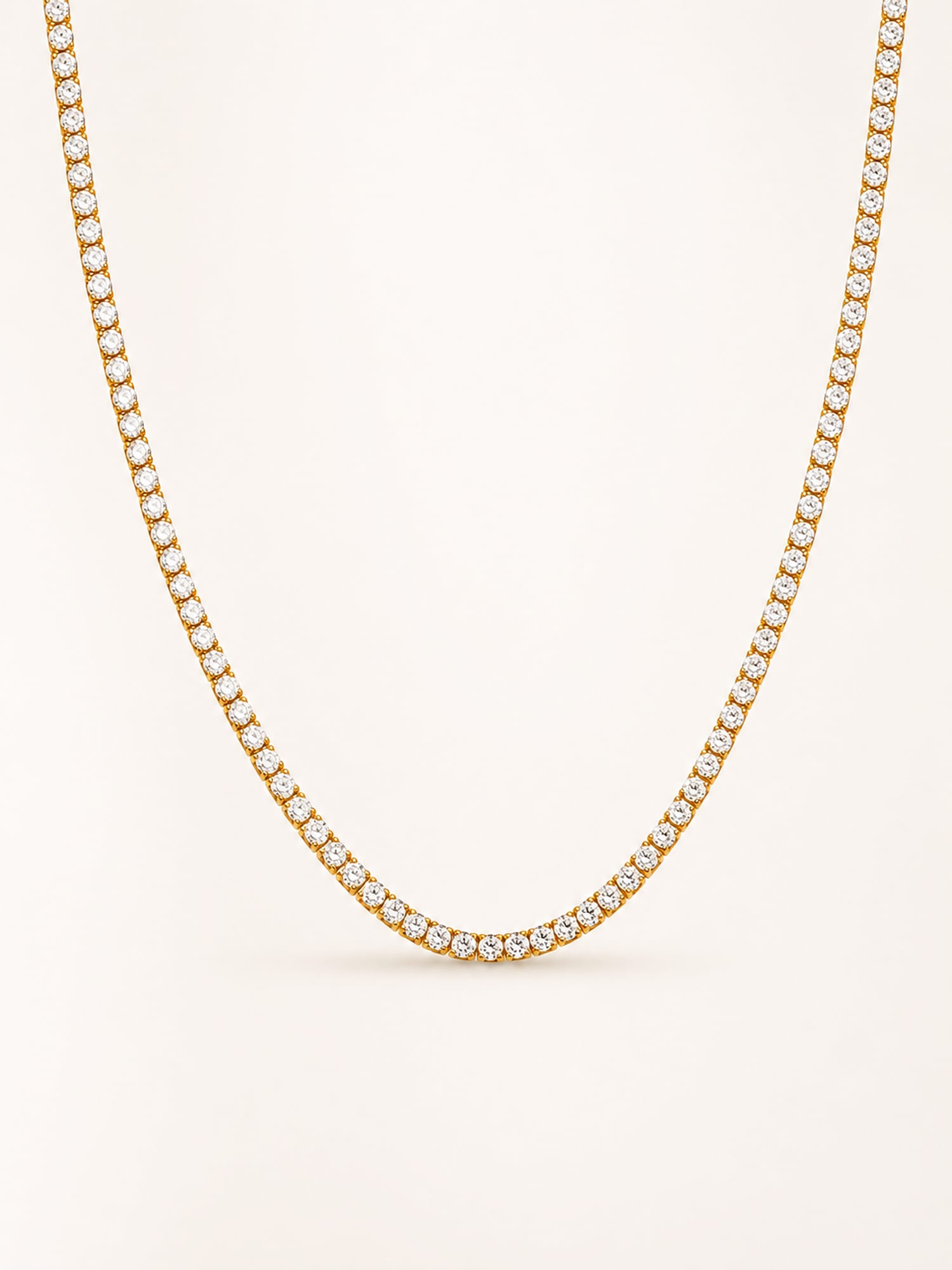 Classic white CZ tennis necklace in 18K gold plated stainless steel with a continuous row of brilliant round stones.