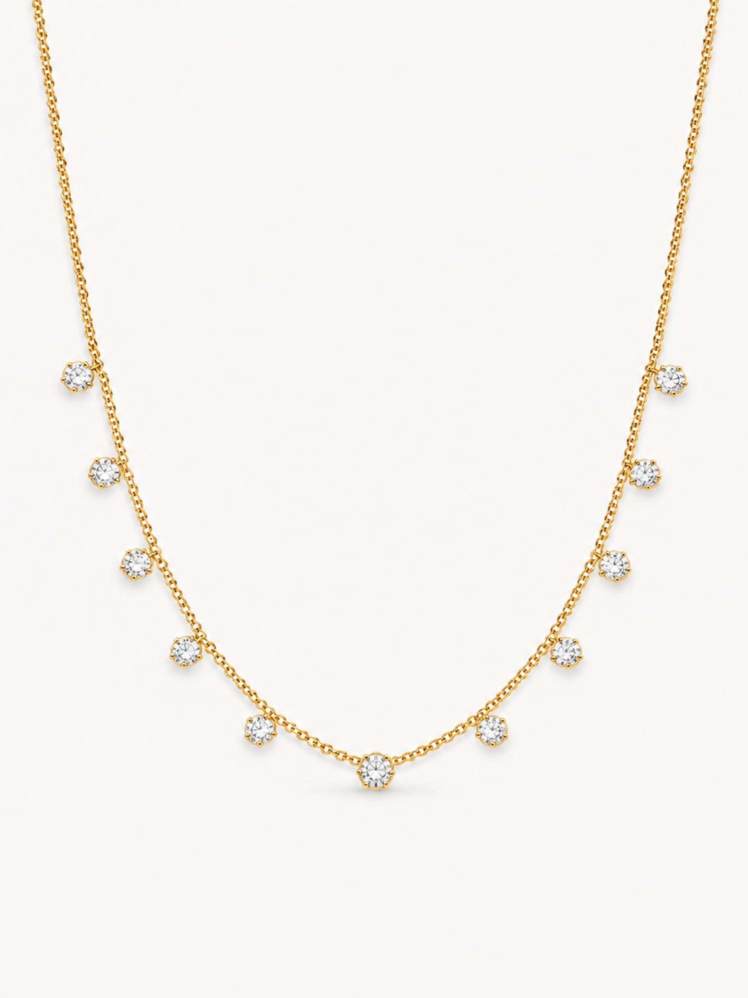 Dainty round CZ station necklace in 18K gold plated stainless steel with evenly spaced sparkling stones.