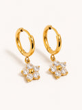 Gold huggie earrings with sparkling six-petal flower charms featuring clear cubic zirconia stones in premium stainless steel.