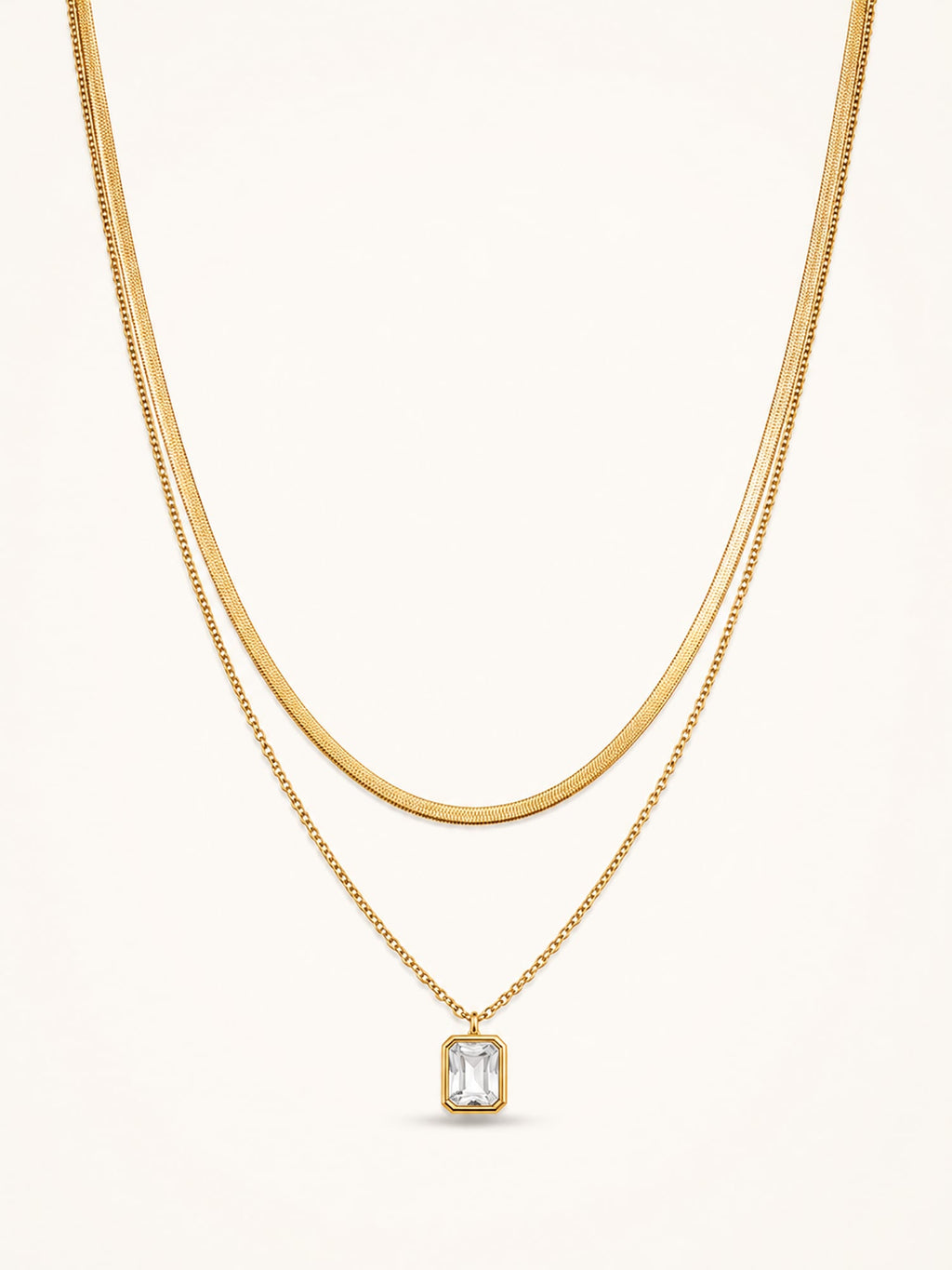 18K gold plated layered necklace with emerald cut cubic zirconia pendant on white background