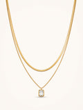 18K gold plated layered necklace with emerald cut cubic zirconia pendant on white background