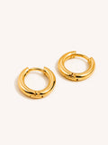 Minimal polished gold huggie hoop earrings crafted from premium stainless steel with 18K Gold Tone PVD plating.