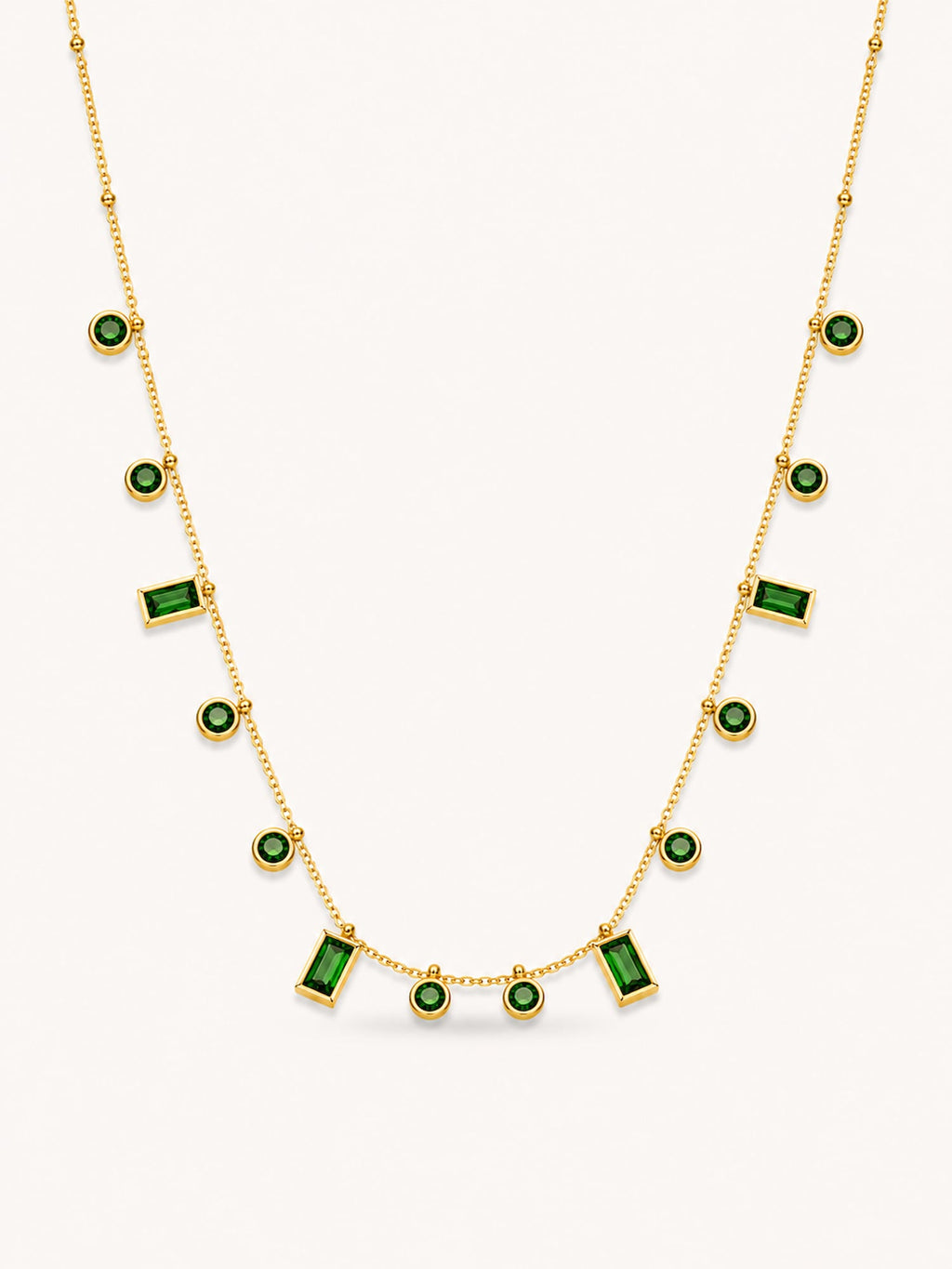Green CZ station necklace featuring alternating round and baguette-cut stones in an 18K gold plated stainless steel chain.