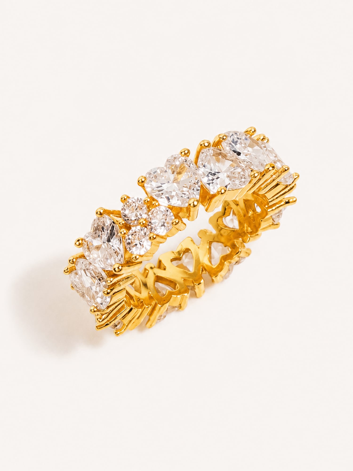 Mixed cut white CZ eternity ring with heart and marquise stones in a polished gold finish.