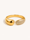 Pavé open wrap ring featuring white cubic zirconia stones in a polished gold finish.