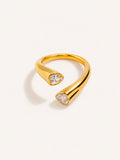 Pear cut open ring featuring two white CZ stones in a polished gold finish.
